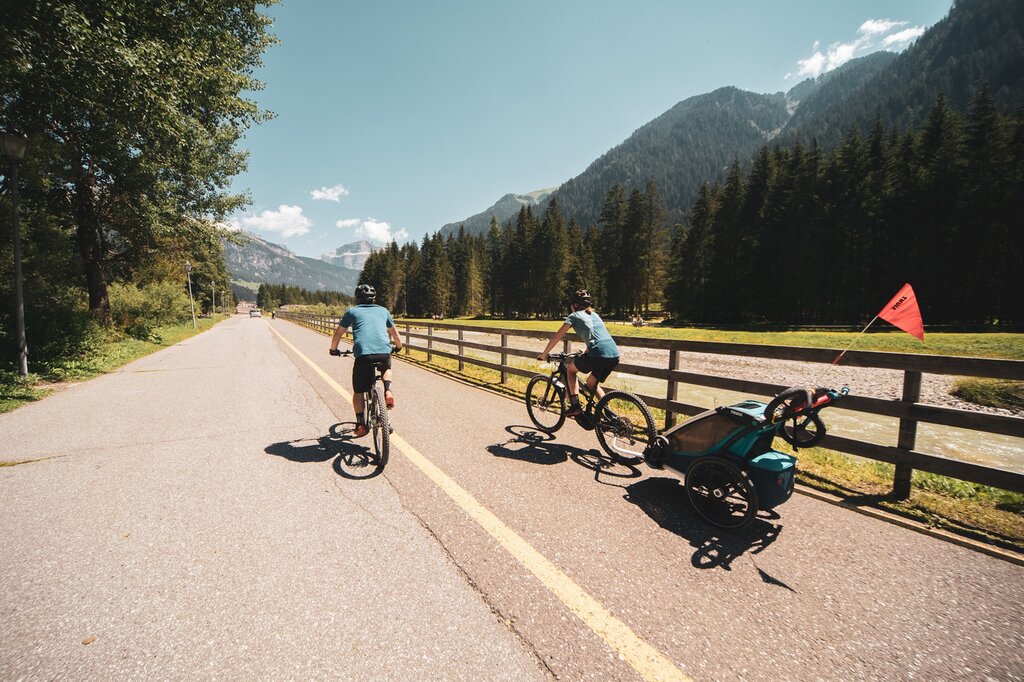 Famiglia sulla ciclabile Famiglia sulla pista ciclabile delle Dolomiti in Val di Fassa
